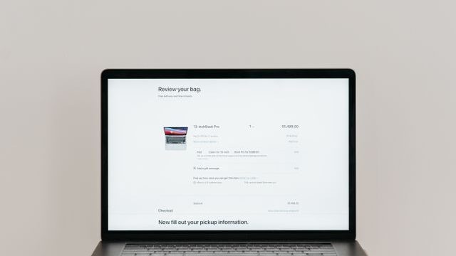 detect AI agent traffic website" — flat conceptual icon of a magnifying glass over a browser window with a faint bot silhouette, muted teal/slate palette